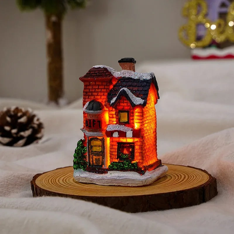 Närbild på ett julbyhus med detaljerad design och varm LED-belysning. Skapar festlig dekoration.