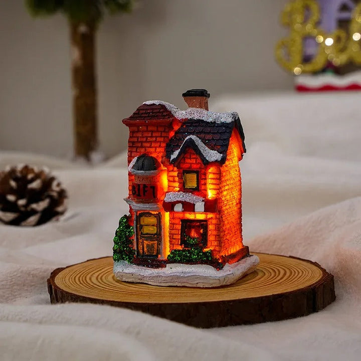 Närbild på ett julbyhus med detaljerad design och varm LED-belysning. Skapar festlig dekoration.