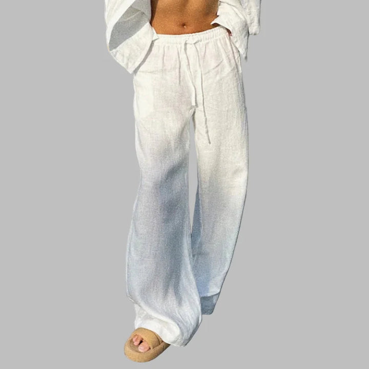 Kvinnors avslappnade byxor i linne-look, designade med hög midja och flytande ben.