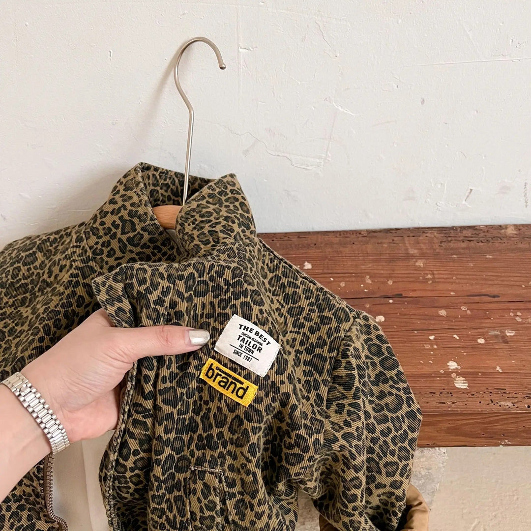 Trendig barnjacka i denim med heltäckande leopardmönster, perfekt för vårens och höstens outfits.