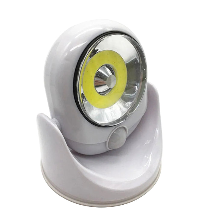 Batteridriven LED-lampa med rörelsesensor och justerbart huvud för flexibel belysning inomhus/utomhus.