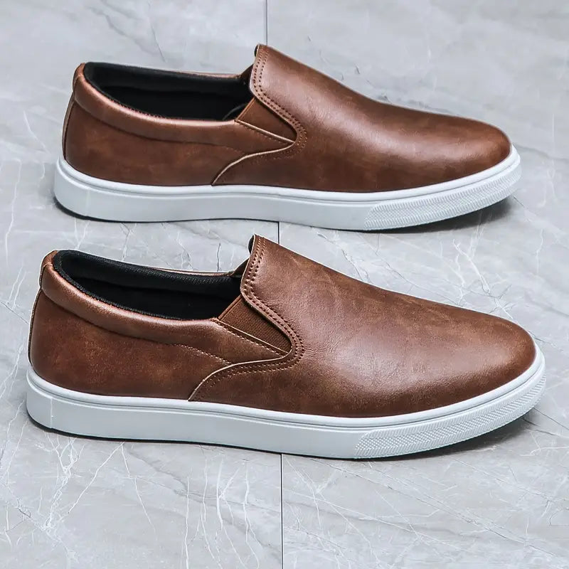 Man bär bekväma herrslippers, visar upp deras stilrena design och funktionalitet för en avslappnad livsstil.