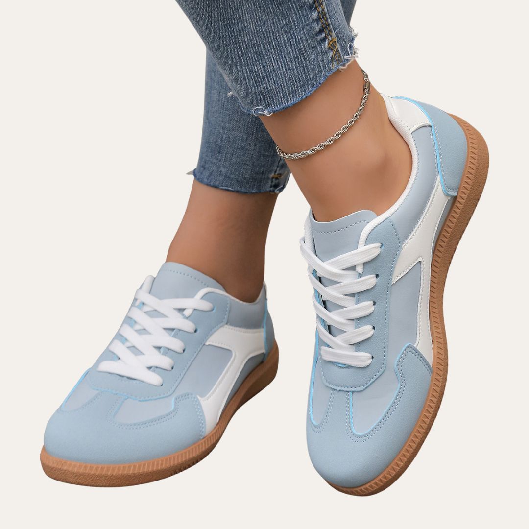 Sidovy av bekväma kvinnors sneakers med fotvalvsstöd, mjuk sula och stilren design för damer.