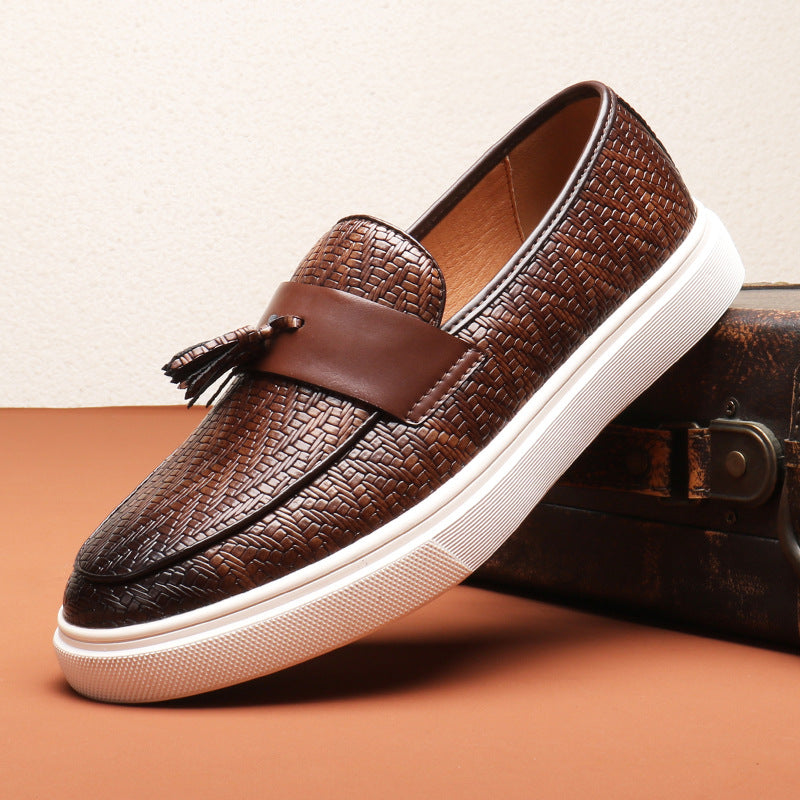 Närbild på bruna tofsar på en stilren slip-on herr-loafer. Mjuka och bekväma fritidsskor.