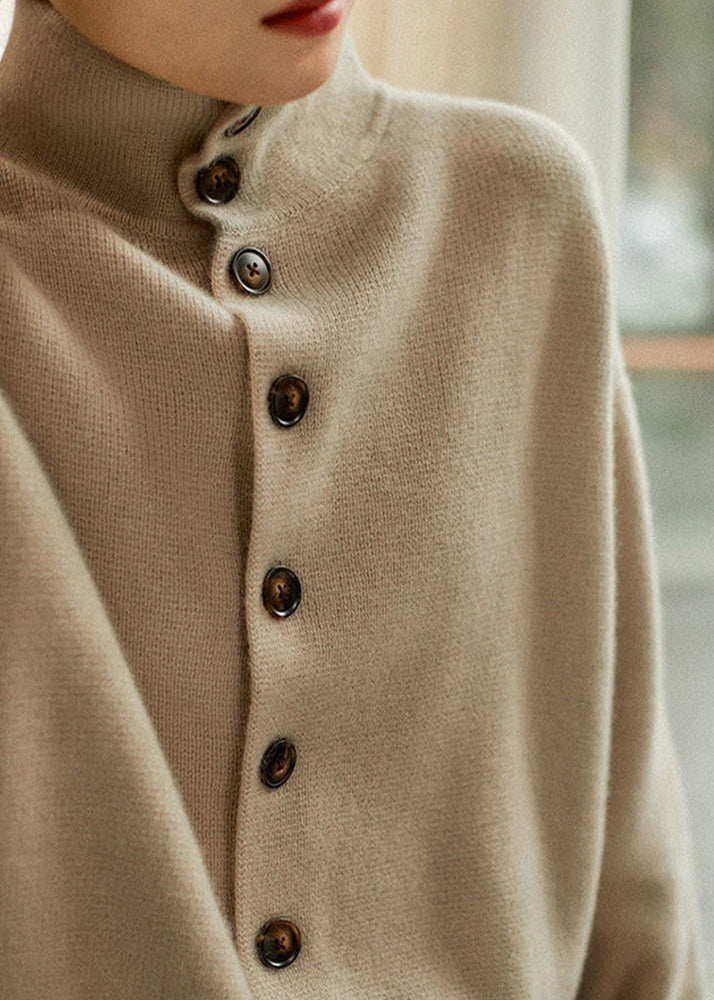 Stickad dam turtleneck tröja med diskreta knappdetaljer vid ärmsluten. Ett måste för vintergarderoben.