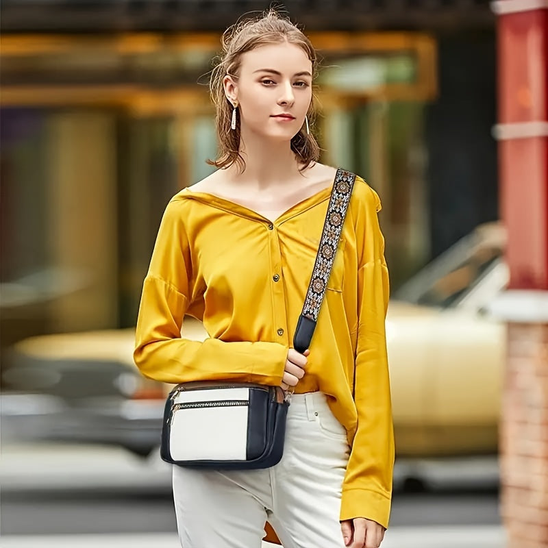 Svart bakgrund som framhäver en brun damernas crossbody-väska i läderlook, stilfull vardagsväska.