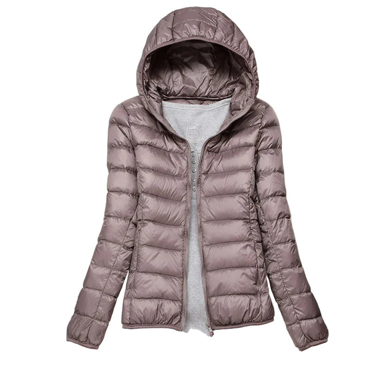 Damjacka med huva för vinter. Stilren, kompakt modejacka för kvinnor. Perfekt som ytterplagg.
