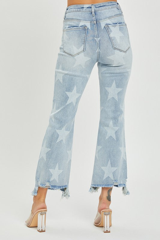 Detaljbild av stjärnmönstrade damjeans i ljus denim. Hög midja och raka ben för en trendig look.