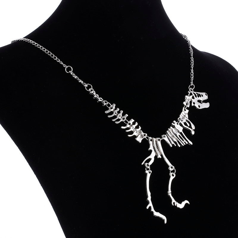 Mångsidigt T-Rex skelett halsband. Unisex smycke i guld zinklegering, perfekt för dinosauriefantaster.