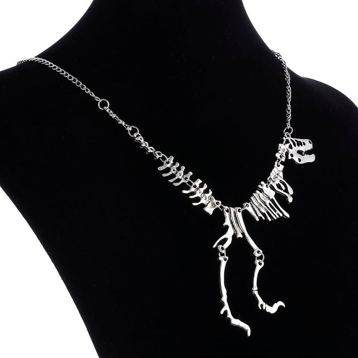 Mångsidigt T-Rex skelett halsband. Unisex smycke i guld zinklegering, perfekt för dinosauriefantaster.