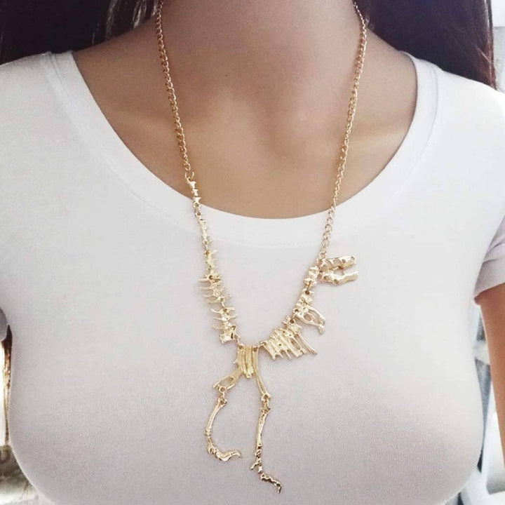 T-Rex skelett halsband, perfekt unisex present för dinosaurieälskare. Smycke i guld zinklegering.