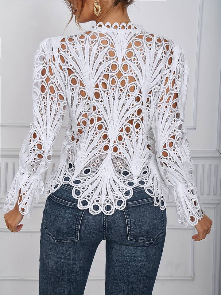 Detaljbild på svart asymmetrisk blus med eleganta utskärningar, kvinnomode.