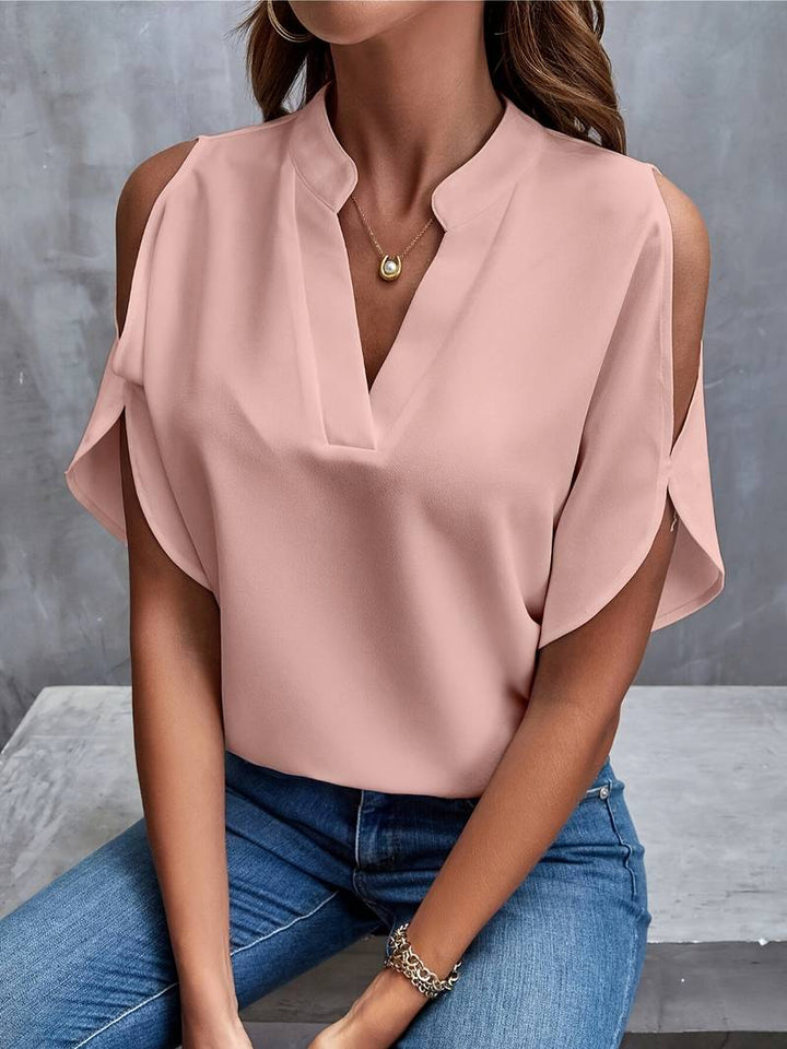 Elegant axelfri damblus i persikofärg, perfekt för sommar och vår. Luftig och feminin vardagsblus.
