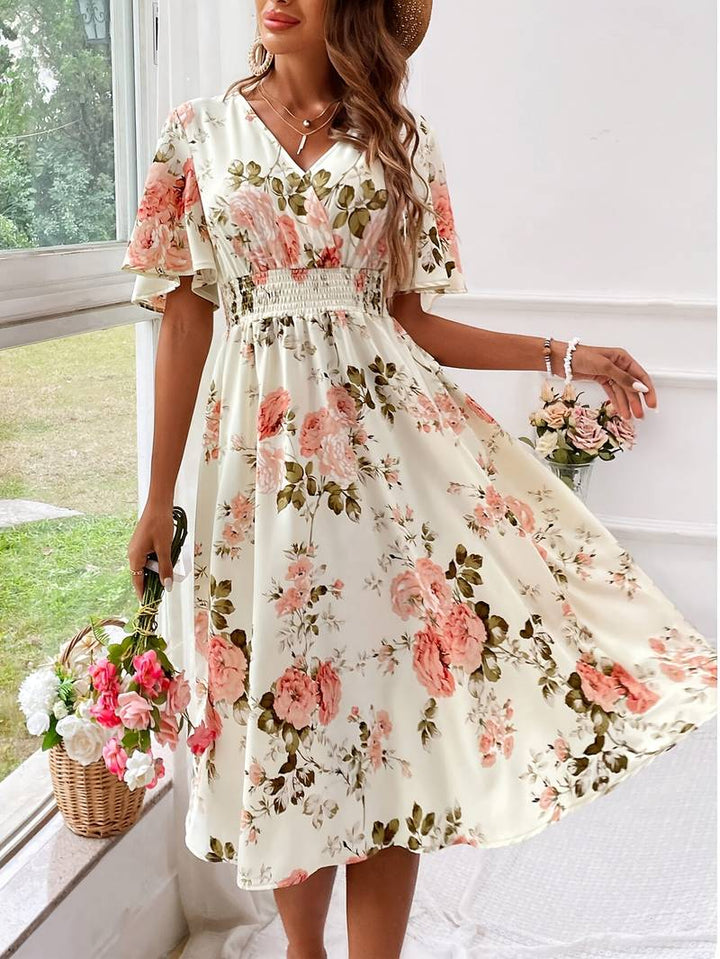 Elegant blommig A-linjeklänning i polyester med v-ringning, perfekt som sommar- eller festklänning för kvinnor.