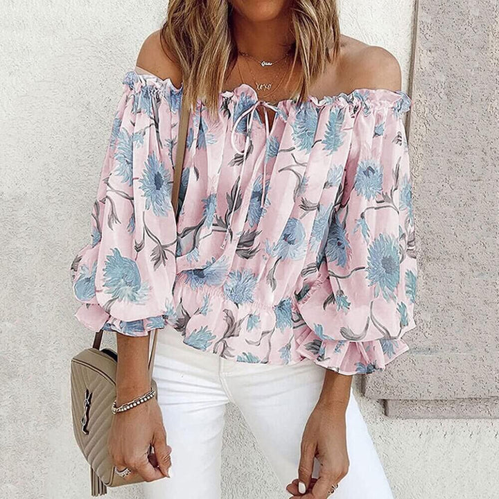 Graciös off shoulder-topp för dam med blommigt tryck & volangdetaljer. Elegant blus för fest & vardag.