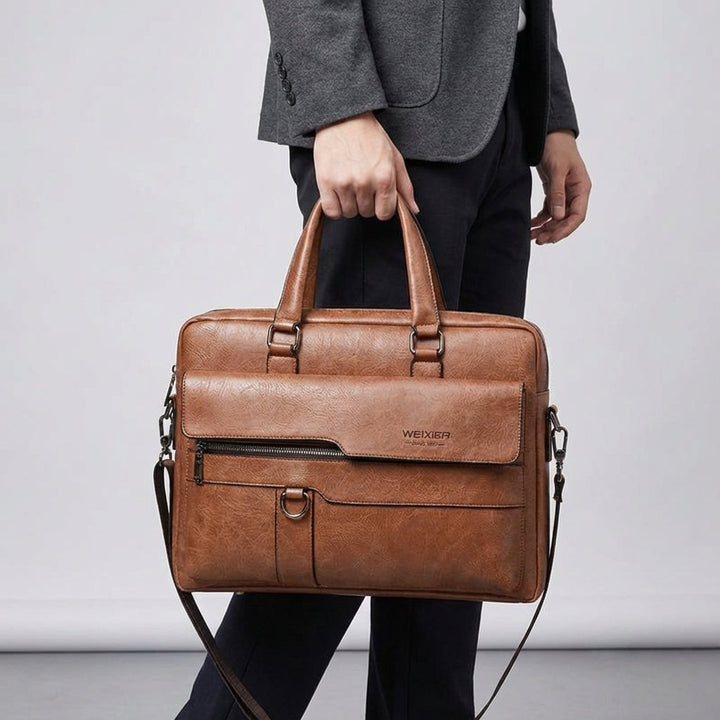 Professionell pendlarväska i PU-läder med justerbar axelrem. Perfekt för laptop & viktiga dokument.