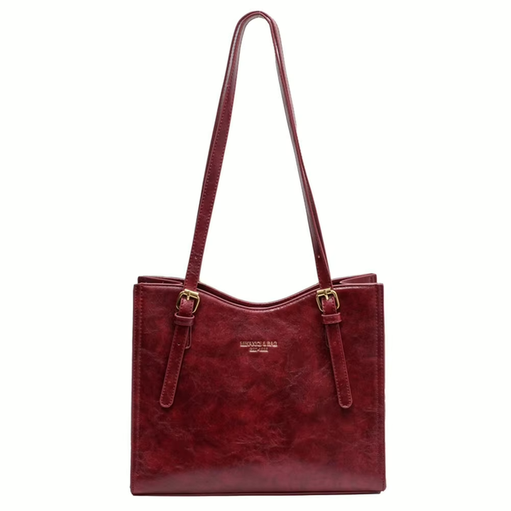 Vinröd toteväska, elegant damhandväska med charm. Rymlig och modern accessoar för modeälskare.