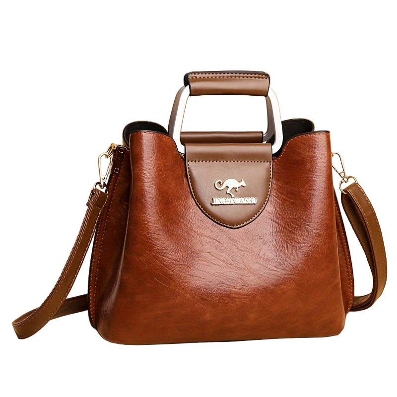 Elegant dam axelväska i läderimitation med justerbar rem, perfekt för vardagsbruk. Stilren crossbody.