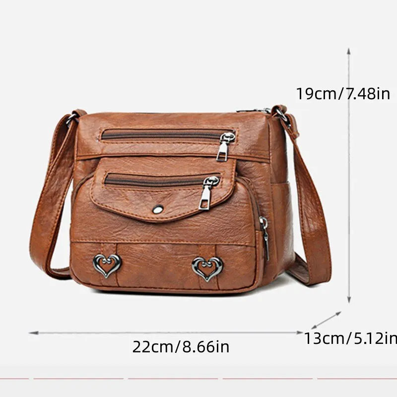 Brun elegant damväska, messenger-stil. Rymlig med dragkedja och fack. Idealisk som crossbodyväska.
