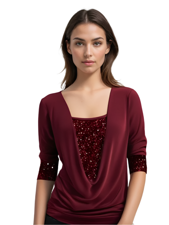 Elegant damblus med draperad halsringning & glittrande detaljer, perfekt för fest eller vardagsmode.