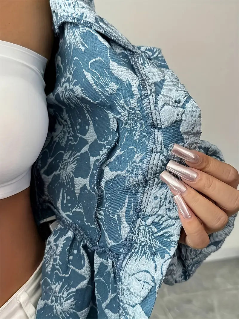 Modern damblus med blommigt mönster och distinkta puffärmar, en elegant topp för alla tillfällen.