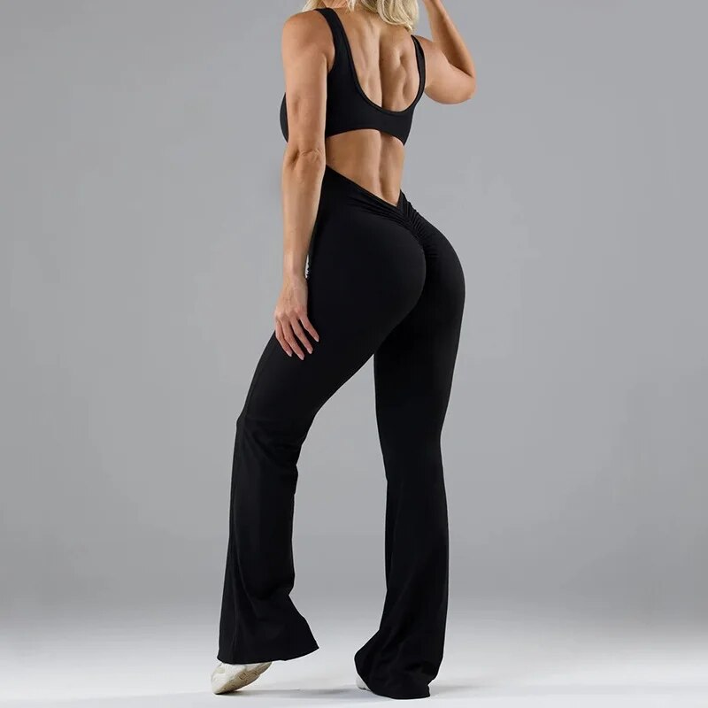 Svart damjumpsuit för fest med unika blommiga mönster på benen och elegant rygglös design.