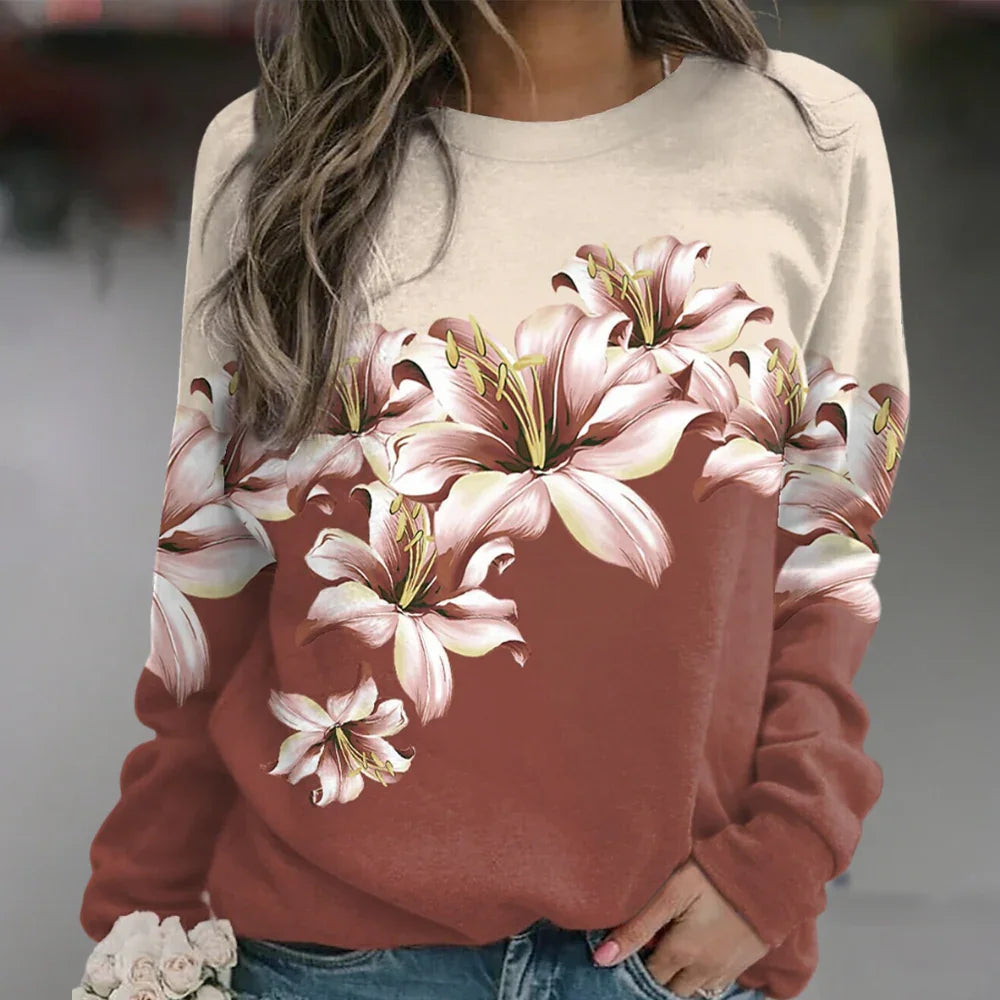 Damtröja med intrikat blommönster och långa ärmar, för en feminin och elegant vardagslook.
