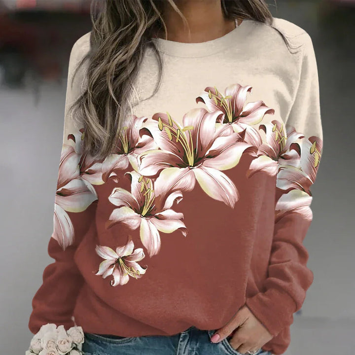 Damtröja med intrikat blommönster och långa ärmar, för en feminin och elegant vardagslook.