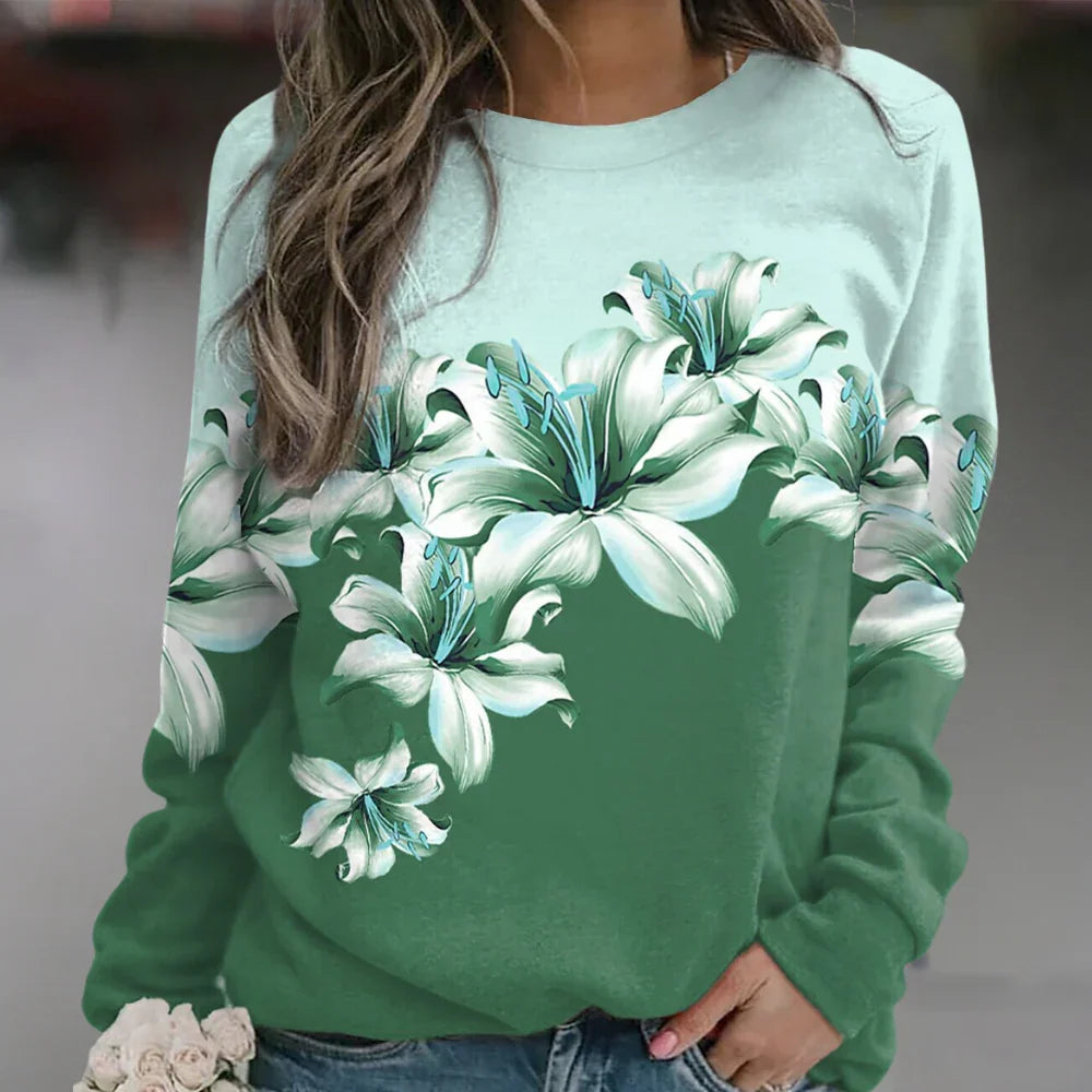 Feminin långärmad damtröja med elegant blommönster, ger en stilfull och bekväm känsla.