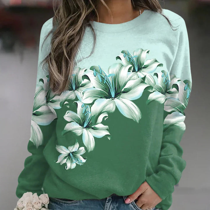 Feminin långärmad damtröja med elegant blommönster, ger en stilfull och bekväm känsla.