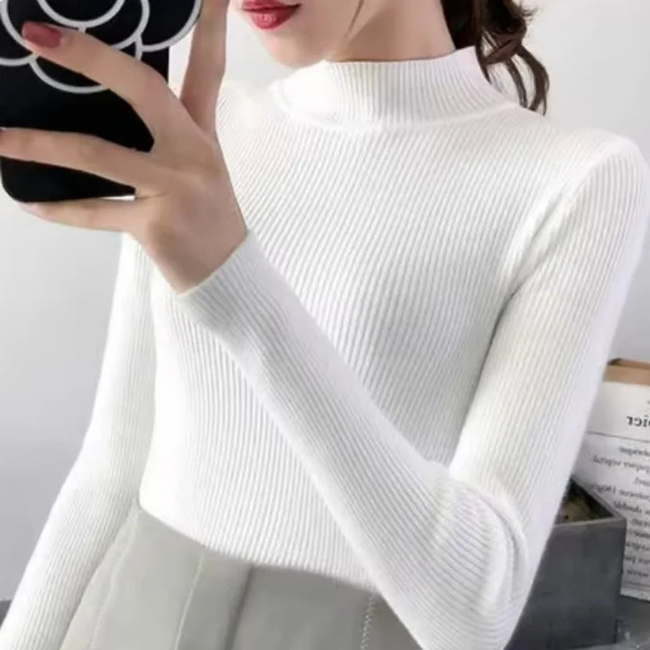Sidoprofil av den bekväma damtröjan med mock neck, framhäver den smickrande slim fit.