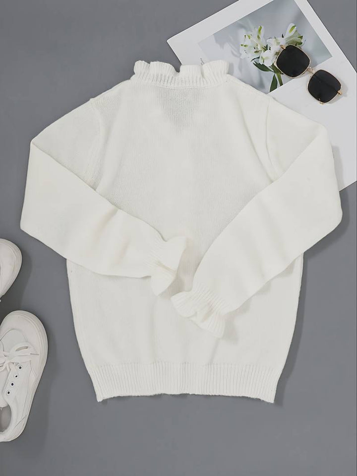 Bekväm stickad damtröja med V-hals, detaljerade knappar och modern vardagslook.