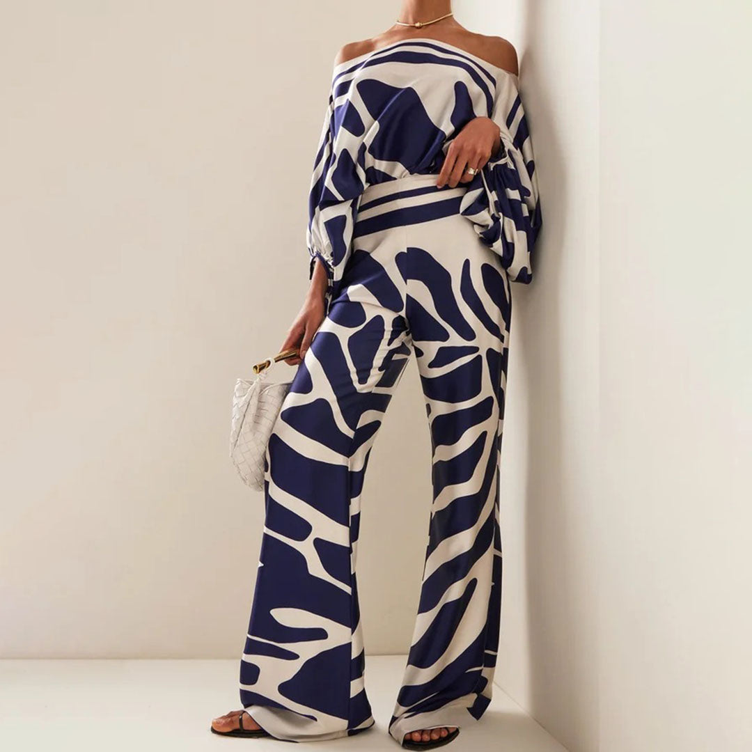 Trendigt orange tvådelat sommarset för dam med off-shoulder. Stilren modeoutfit, idealisk för soliga sommardagar.