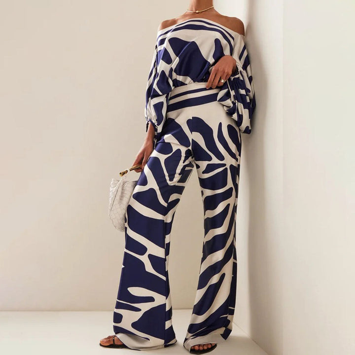 Trendigt orange tvådelat sommarset för dam med off-shoulder. Stilren modeoutfit, idealisk för soliga sommardagar.