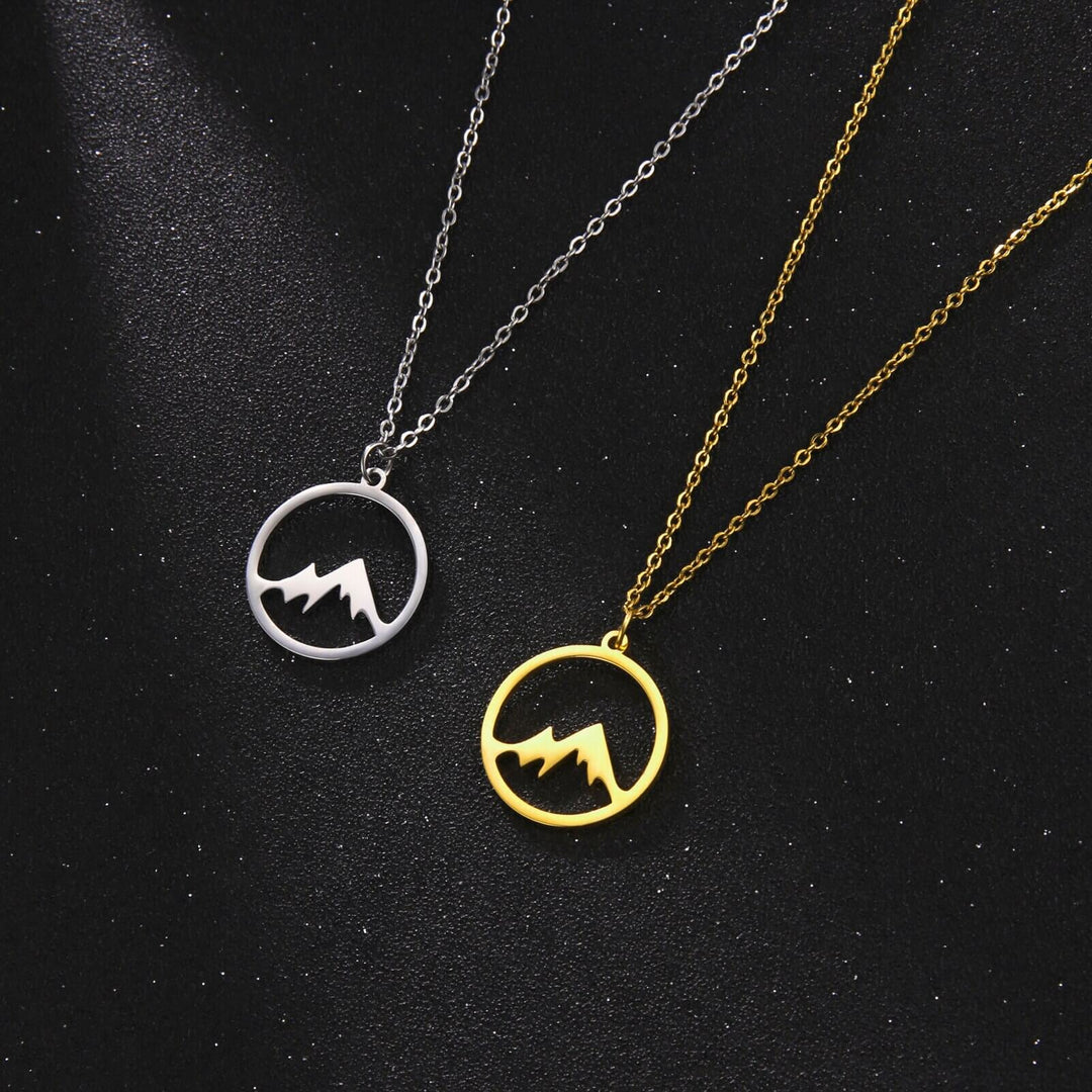 Modernt designat bergsbacken halsband i guld för kvinnor. Symbol för oberoende och styrka.