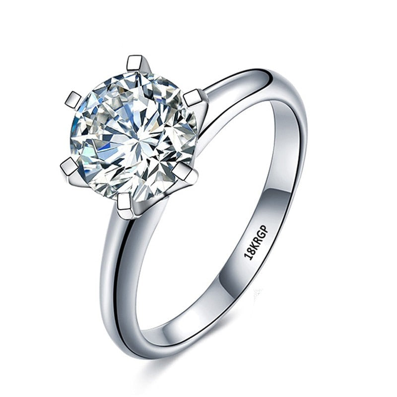 Elegant löftesring för damer i vitguldpläterad finish med gnistrande zirkoniasten, tidlös diamantstil.