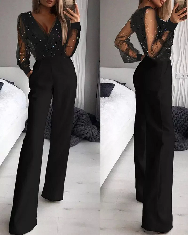Glamourös skimrande jumpsuit för speciella tillfällen. Långärmad modell med vida ben för partyoutfit.