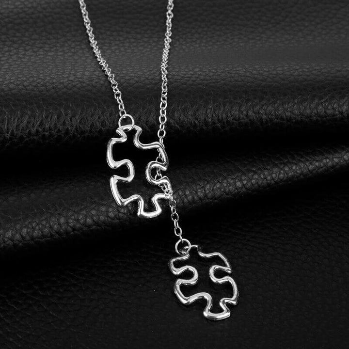 Stilrent pusselhalsband för kvinnor, symboliserar autismmedvetenhet. Ett elegant smycke.