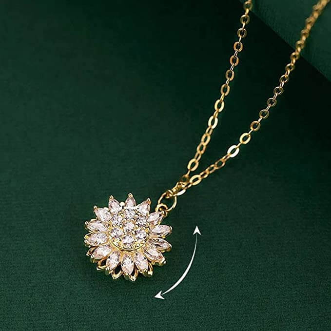 Vackert snurrande solros halsband med spinnerfunktion i guld. Idealisk present för kvinnor, ger lugn.