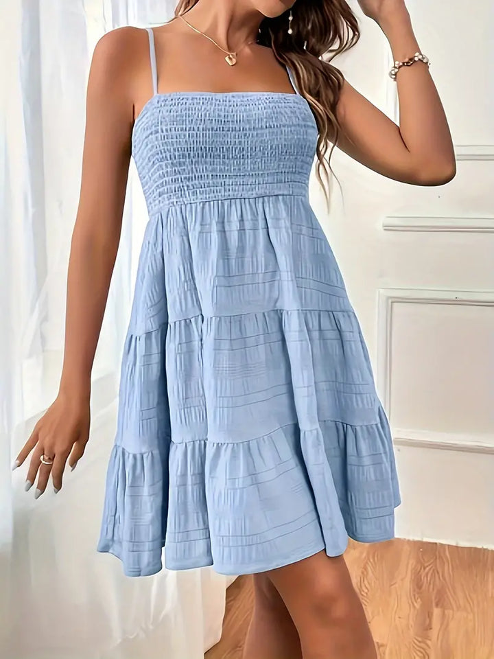Strukturerad damklänning i cami-modell. Bekväm och elegant sommarklänning, perfekt för semester.