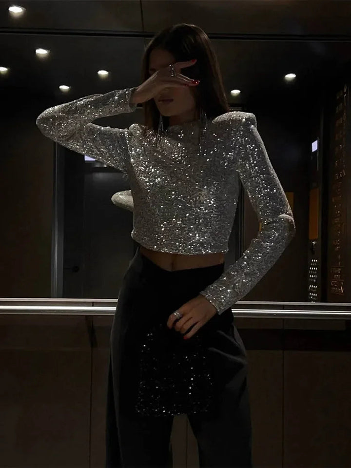 Långärmad paljett-crop top i svart för kvinnor, en glittrig modetopp för festliga tillfällen.