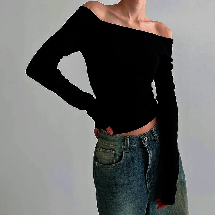 Elegant svart långärmad offshoulder topp för dam, figurnära design. Perfekt för fest & vardag.