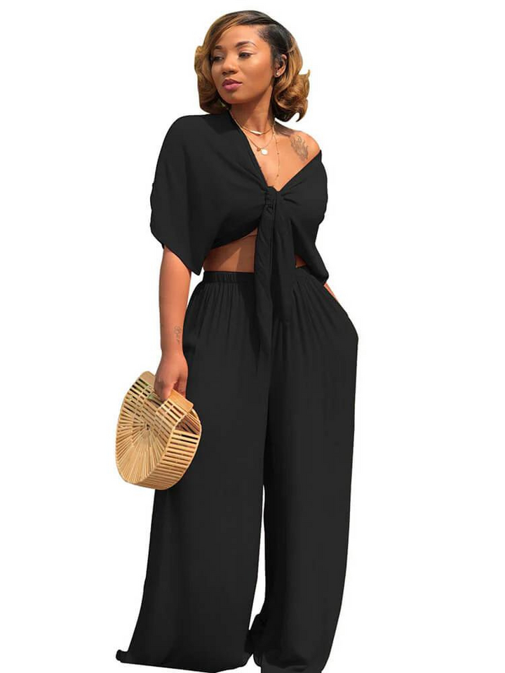 Dam tvådelat set: stilren crop top och flödande vida byxor, bekväm sommarstil med elegans.