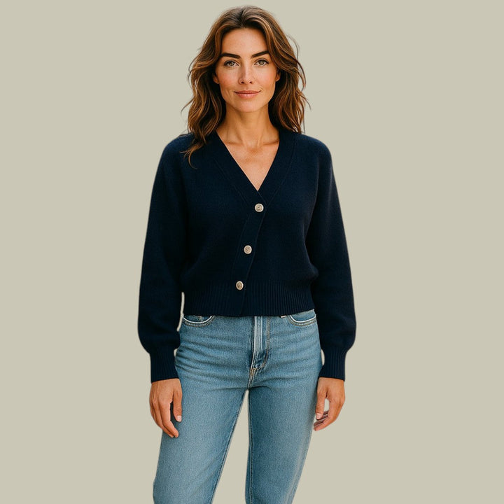 Kvinnors V-ringad tröja med unika korsknappar, perfekt för en elegant och asymmetrisk stil.