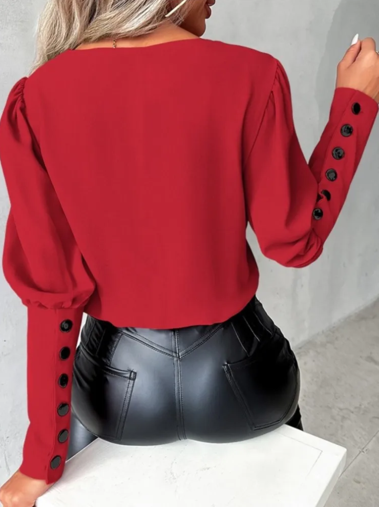 Närbild av V-ringad blus för kvinnor som visar elegant tygtextur och avslappnad modekänsla.