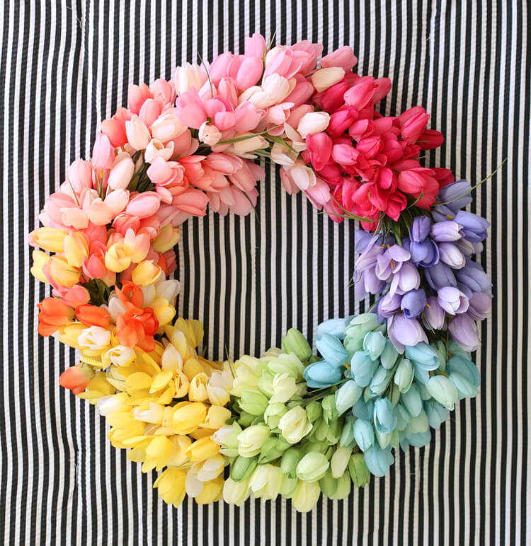 Detaljrik tulpan vårkrans med verklighetstrogna konstgjorda blommor. En färggrann accent för hemmet.