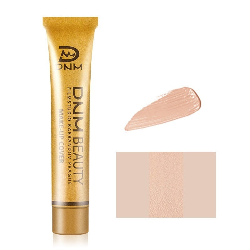 Liten mängd krämig fulltäckande concealer på huden, redo att blandas för en naturlig, felfri finish.