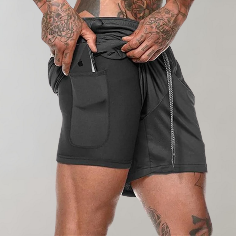 Herr träningsshorts med fickor och reflekterande detaljer för ökad synlighet.