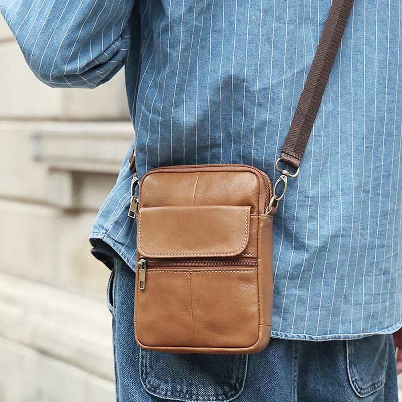 Organiserad herr axelväska med flera fack. Rymlig pendlarväska för surfplatta, stilren crossbody.