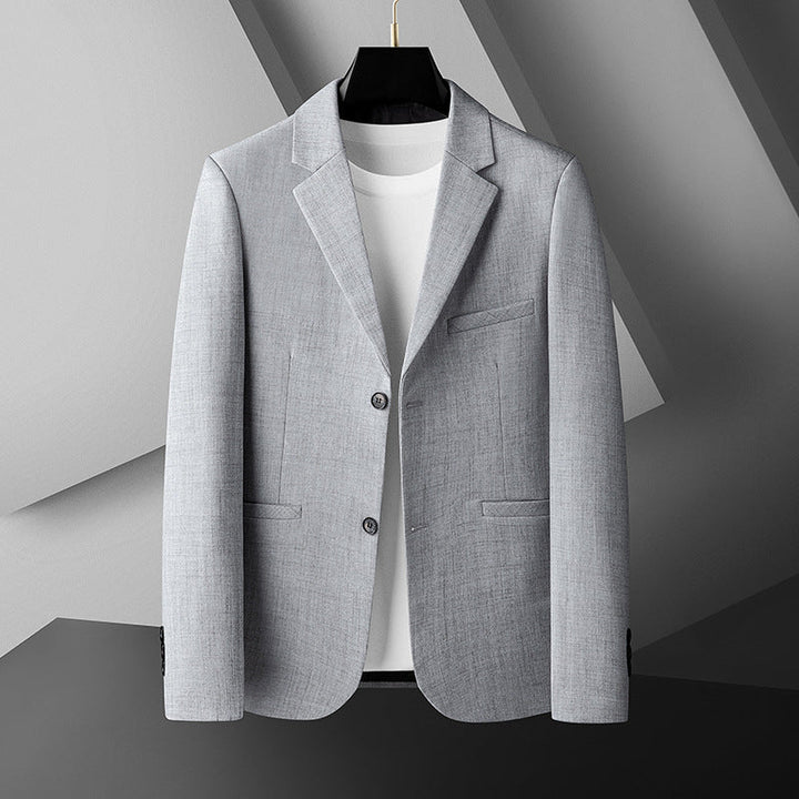 Beige herrblazer i modern passform med stilren krage. Mångsidig kostymjacka för fritid och festkläder.
